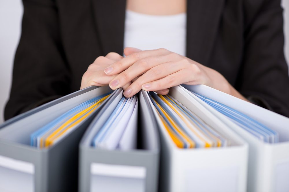 businesswoman with binders at office