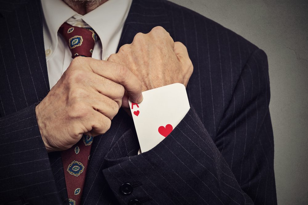 senior man hand pulling out a hidden ace from the sleeve